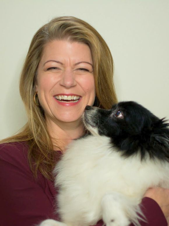 Angela holding her dog