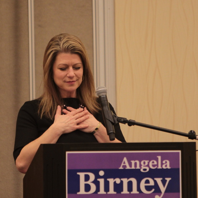 Angela at a podium