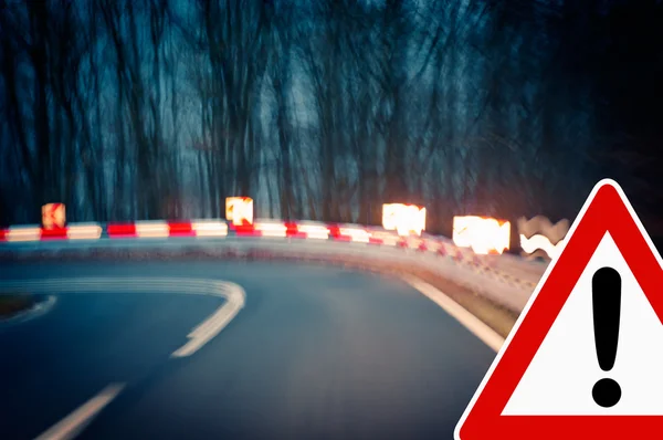 Warning sign at a sharp corner in a road